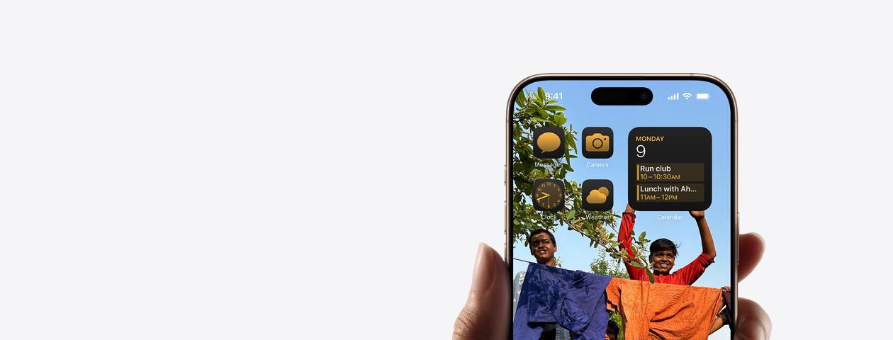 Hand holding iPhone with home screen